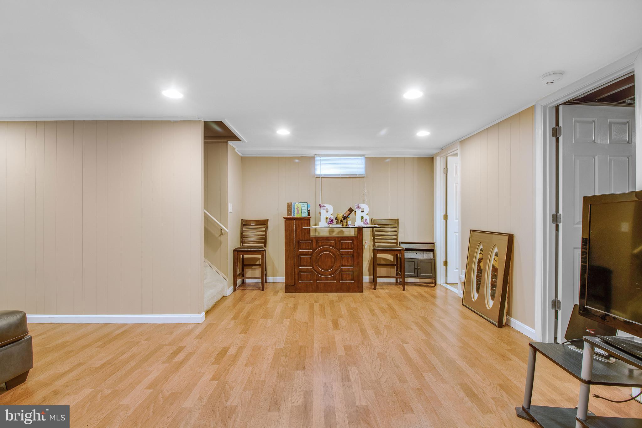 3708 Collier Road Randallstown, MD 21133 - Photo 19 of 25 a view of a livingroom with furniture and a flat screen tv