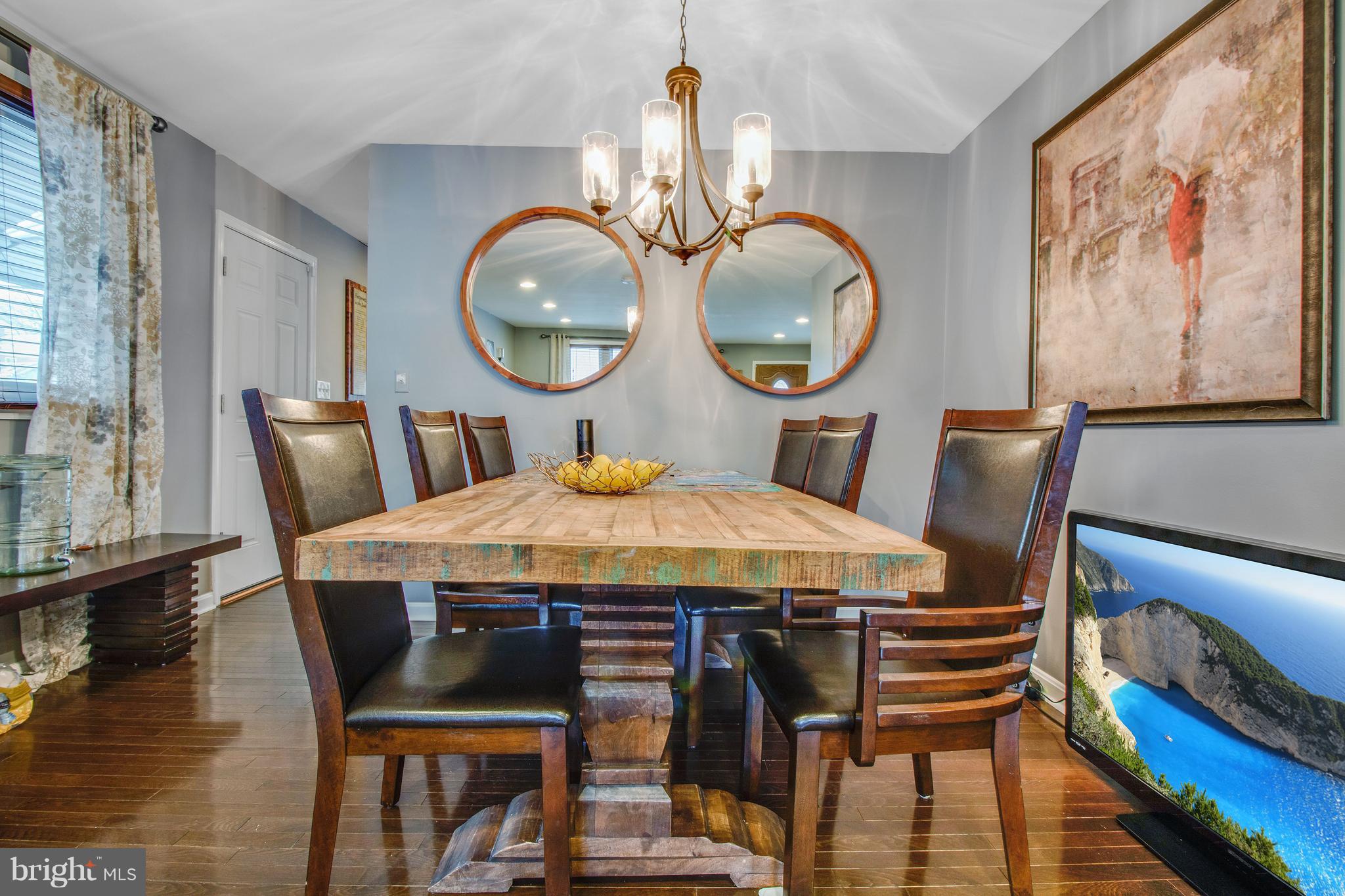 3708 Collier Road Randallstown, MD 21133 - Photo 6 of 25 a dining room with furniture a mirror and wooden floor