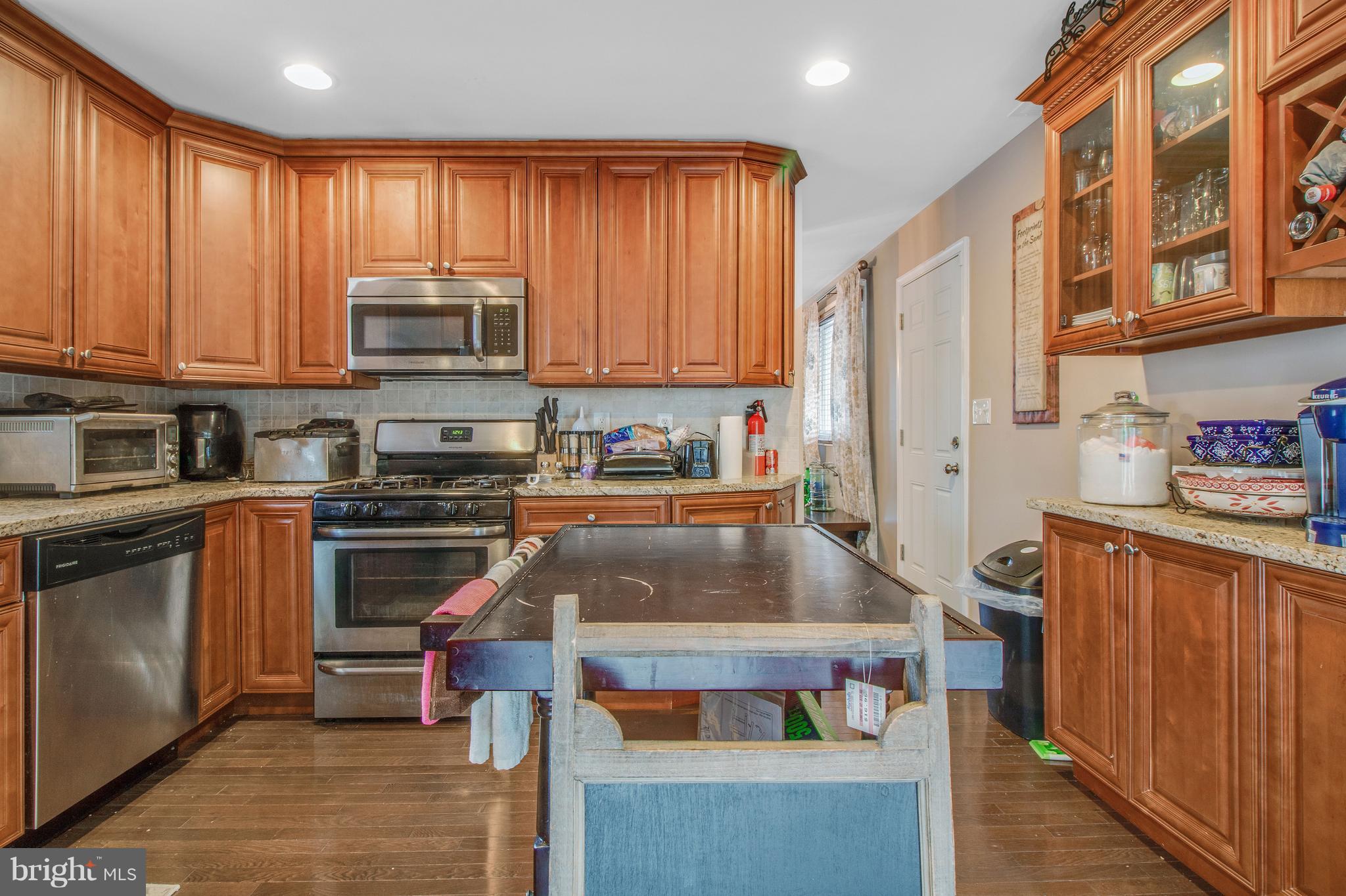 3708 Collier Road Randallstown, MD 21133 - Photo 7 of 25 a kitchen with stainless steel appliances a stove a sink and a microwave