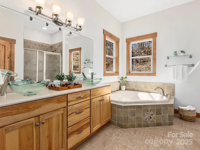 a spacious bathroom with a tub sink and mirror