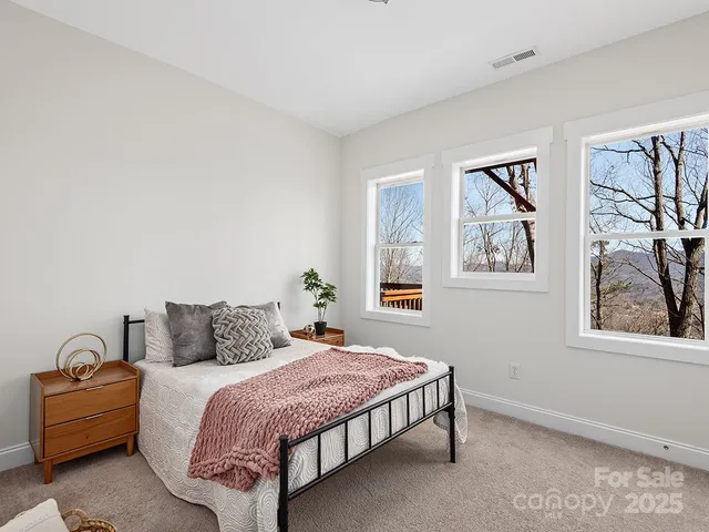 a bedroom with a bed and a painting on the wall