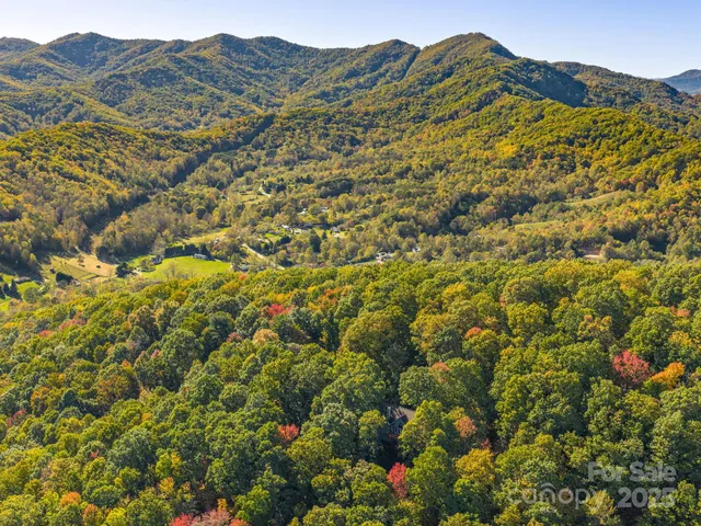 a view of a large mountain with mountains in the background
