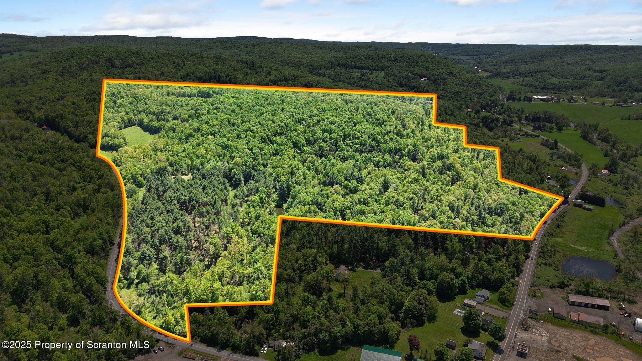 Quaker Lake Road Friendsville, PA 18818 - Photo 1 of 12 an aerial view of mountain with a yard
