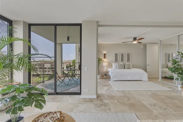 a bedroom with a large bed and a potted plant