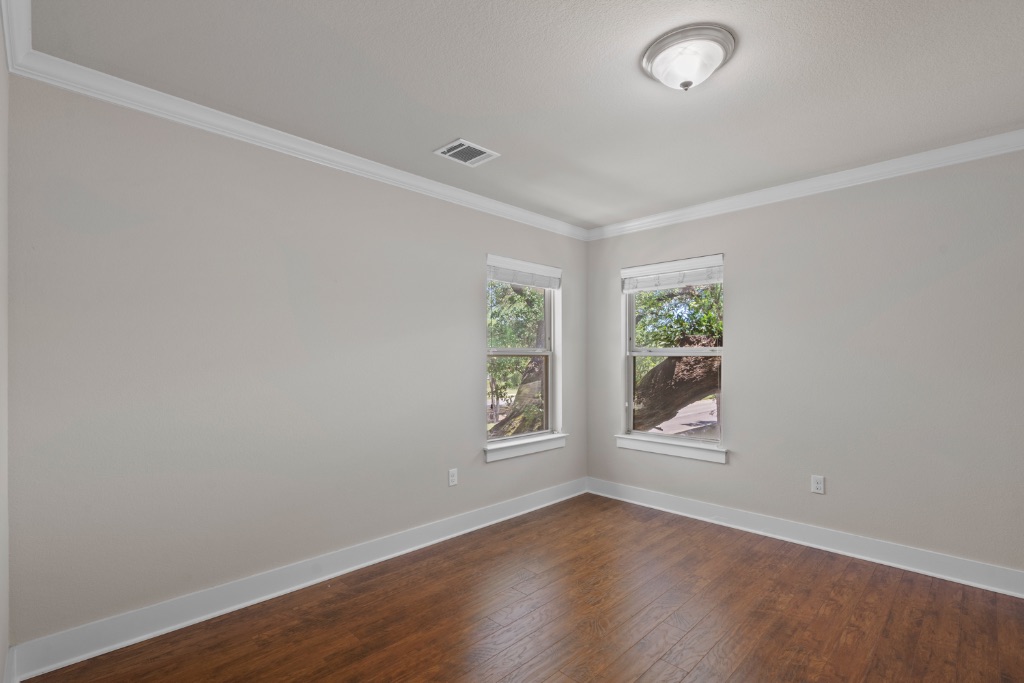 11229 Avery Station Loop, Unit 36 Austin, TX 78717 - Photo 27 of 37 Empty room featuring dark wood finished floors and ornamental molding