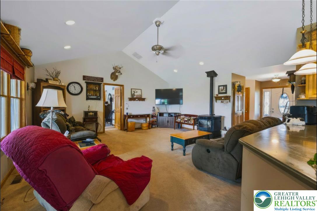 6970 Silver Crest Road Nazareth, PA 18064 - Photo 9 of 35 A generous living area presents high vaulted ceilings and a cozy wood-burning stove.