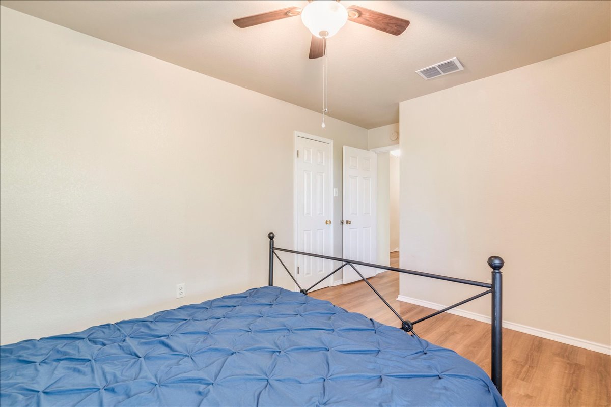 9300 Tea Rose Trail Austin, TX 78748 - Photo 26 of 33 Functional bedroom with wood flooring and a classic ceiling fan offers versatile comfort.