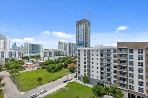 a bedroom with a large bed and a painting on the wall