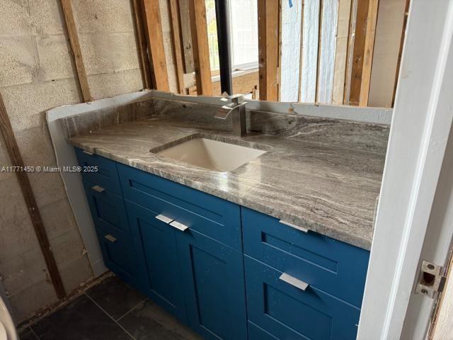 162 Tropical Shore Way Fort Myers Beach, FL 33931 - Photo 14 of 32 a bathroom with a granite countertop sink and a large mirror