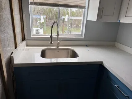 a kitchen with a sink and a window