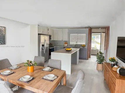 a living room with furniture a flat screen tv and a window