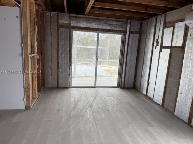 162 Tropical Shore Way Fort Myers Beach, FL 33931 - Photo 8 of 32 a view of empty room with wooden floor and fan