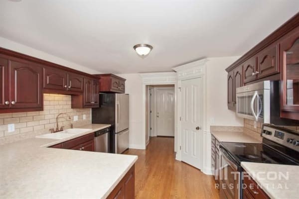 2911 Wolves Trail Murfreesboro, TN 37127 - Photo 7 of 15 a kitchen with stainless steel appliances granite countertop a sink stove and refrigerator