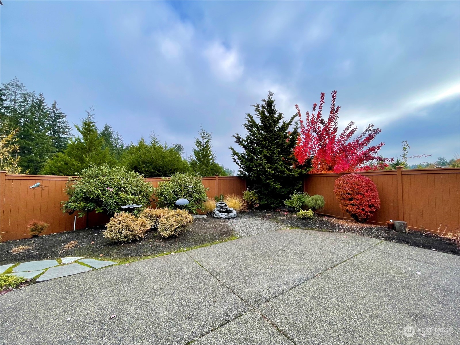 5018 Cypress Loop Northeast Lacey, WA 98516 - Photo 18 of 30 a flower garden is sitting in the middle of a yard