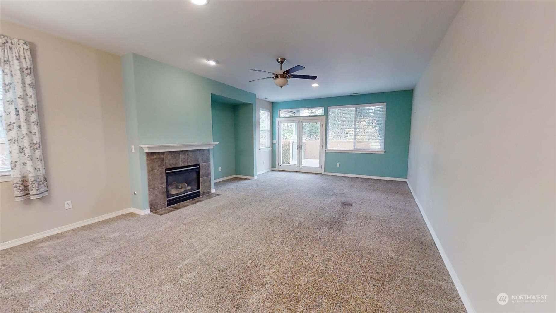 5018 Cypress Loop Northeast Lacey, WA 98516 - Photo 4 of 30 an empty room with windows and fireplace
