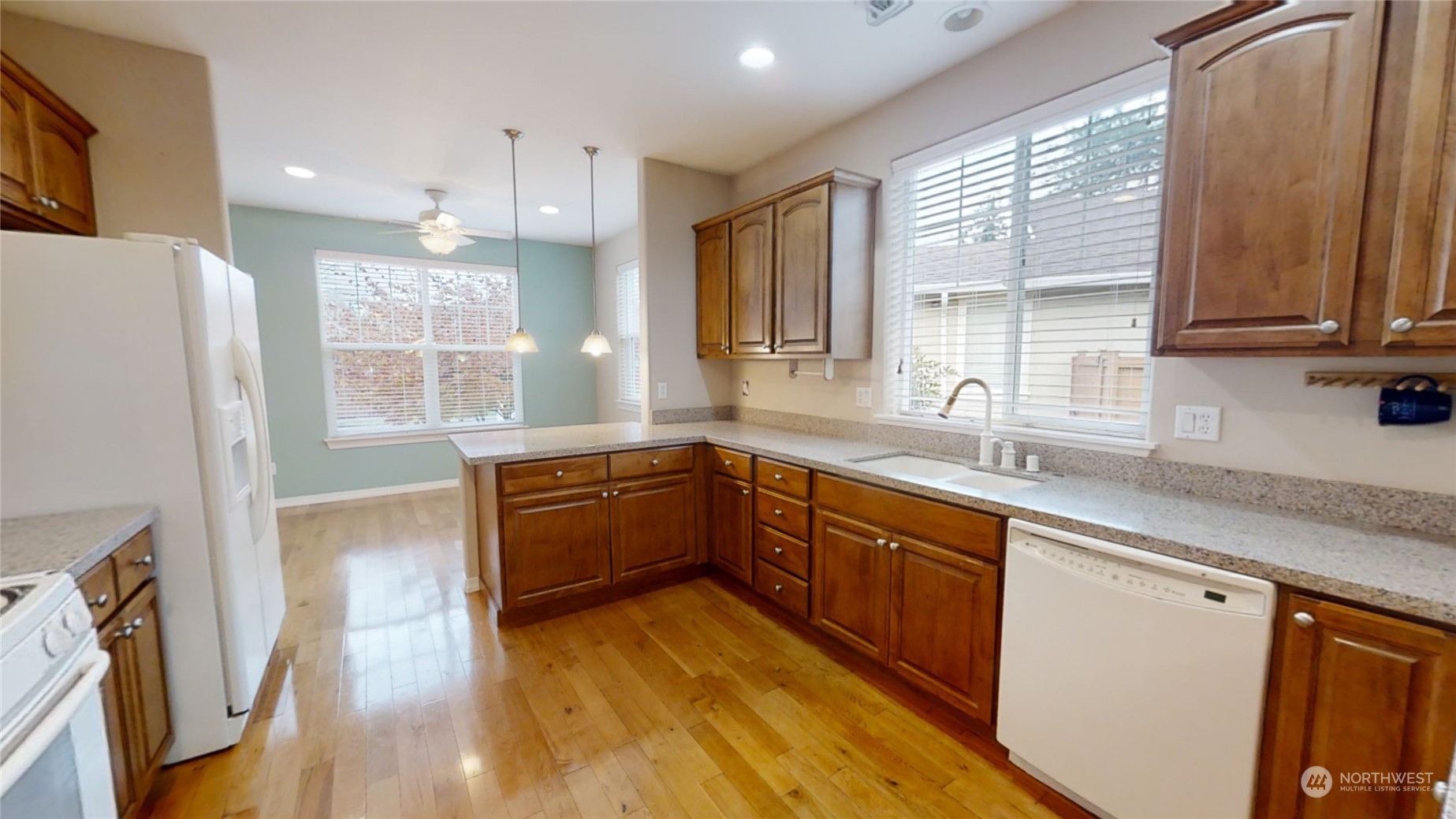 5018 Cypress Loop Northeast Lacey, WA 98516 - Photo 7 of 30 a kitchen with stainless steel appliances granite countertop wooden floors a stove a sink and a window