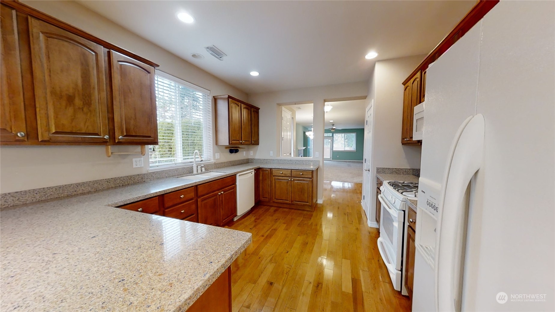 5018 Cypress Loop Northeast Lacey, WA 98516 - Photo 8 of 30 a kitchen with stainless steel appliances granite countertop sink stove refrigerator and cabinets