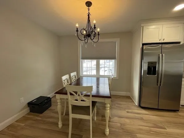 a view of a dining room with furniture wooden floor and chandelier