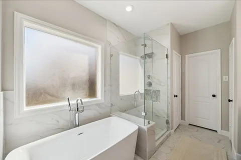 a bathroom with a tub a toilet and a sink