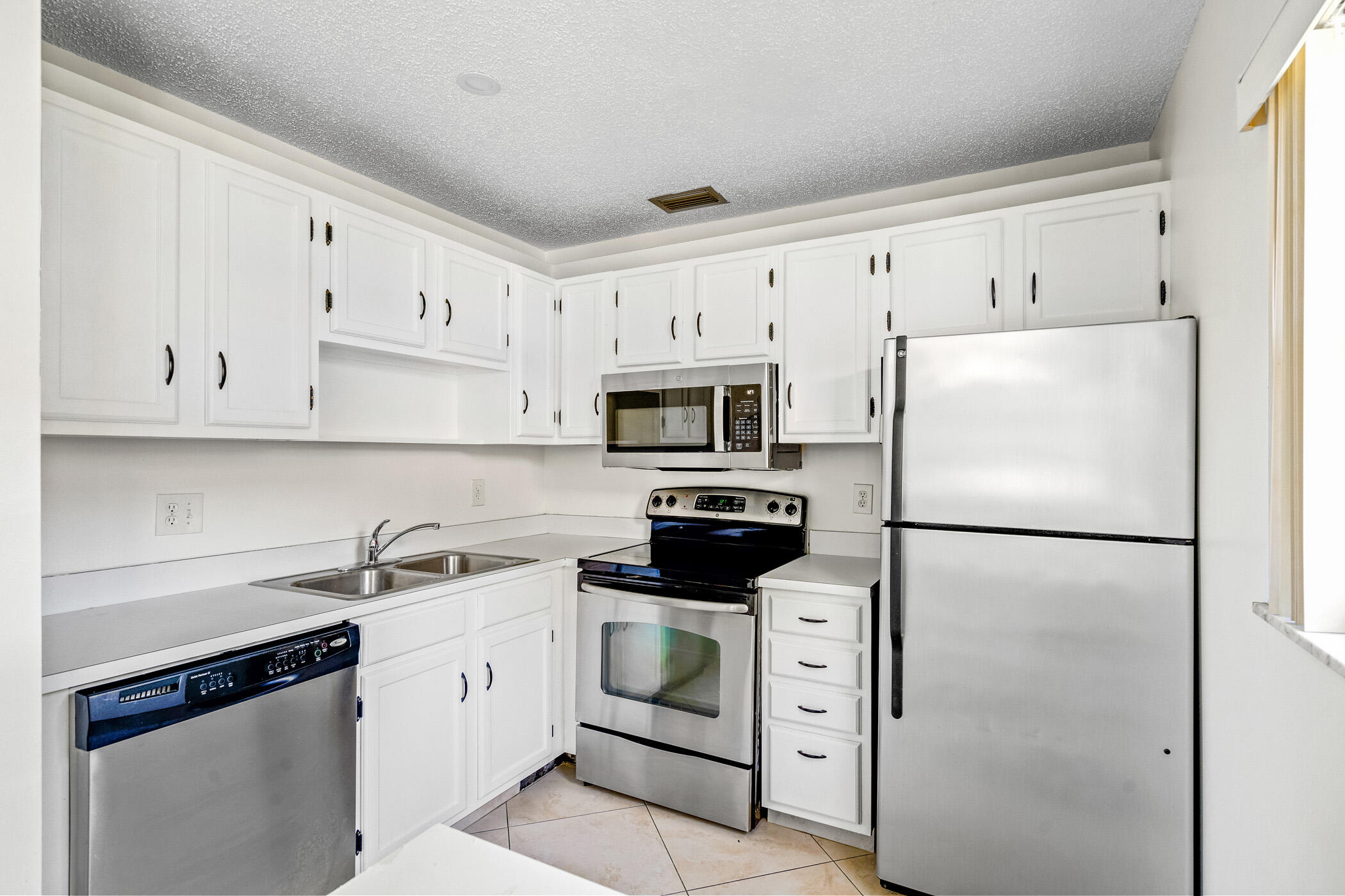 Undisclosed Address Vero Beach, FL 32962 - Photo 8 of 34 a white refrigerator freezer sitting in a kitchen