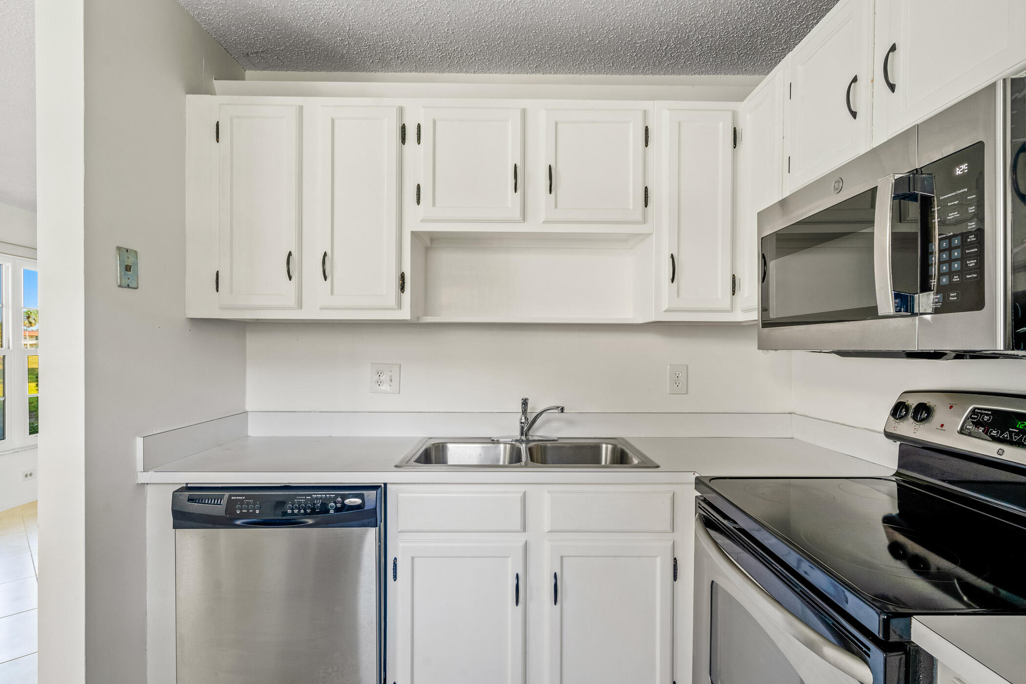 Undisclosed Address Vero Beach, FL 32962 - Photo 9 of 34 a kitchen with stainless steel appliances granite countertop white cabinets a sink and dishwasher