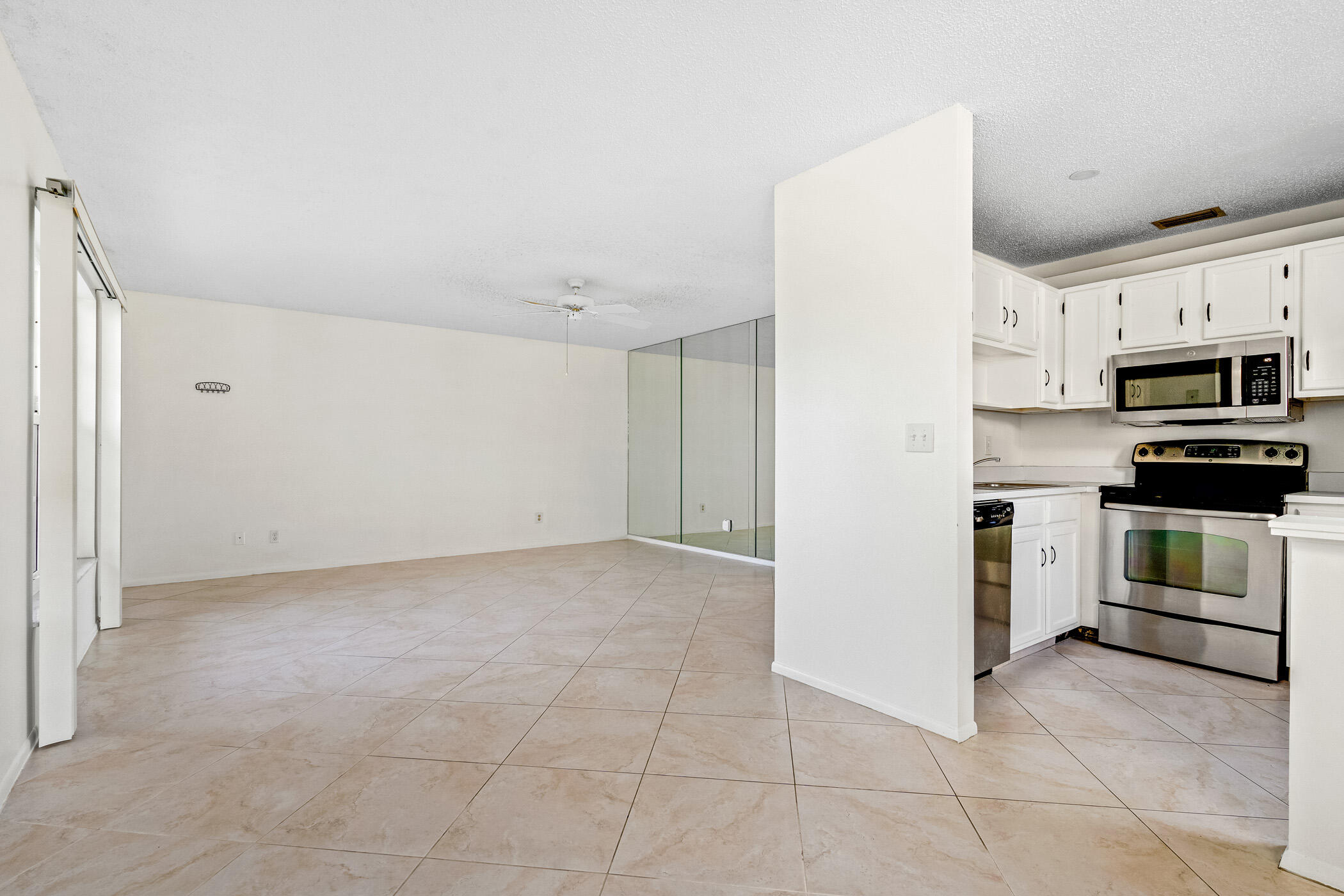 Undisclosed Address Vero Beach, FL 32962 - Photo 10 of 34 a kitchen with stainless steel appliances granite countertop a refrigerator and a stove top oven