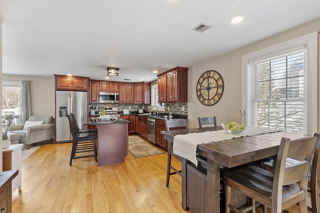 103 Reed Street Rockland, MA 02370 - Photo 11 of 33 a living room with a table and a clock