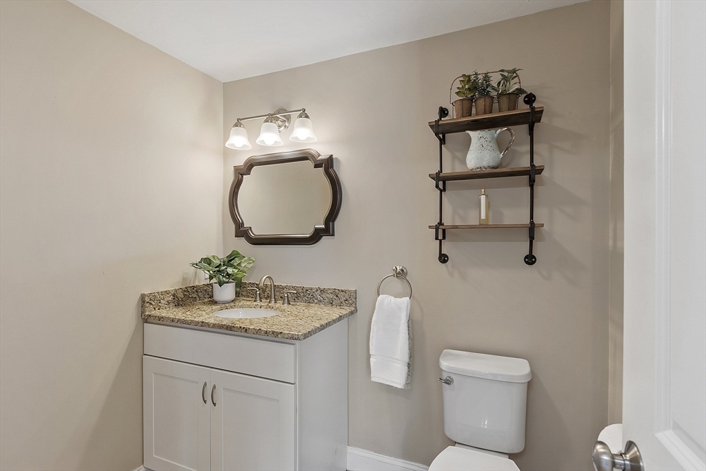 103 Reed Street Rockland, MA 02370 - Photo 17 of 33 a bathroom with a toilet a sink and mirror