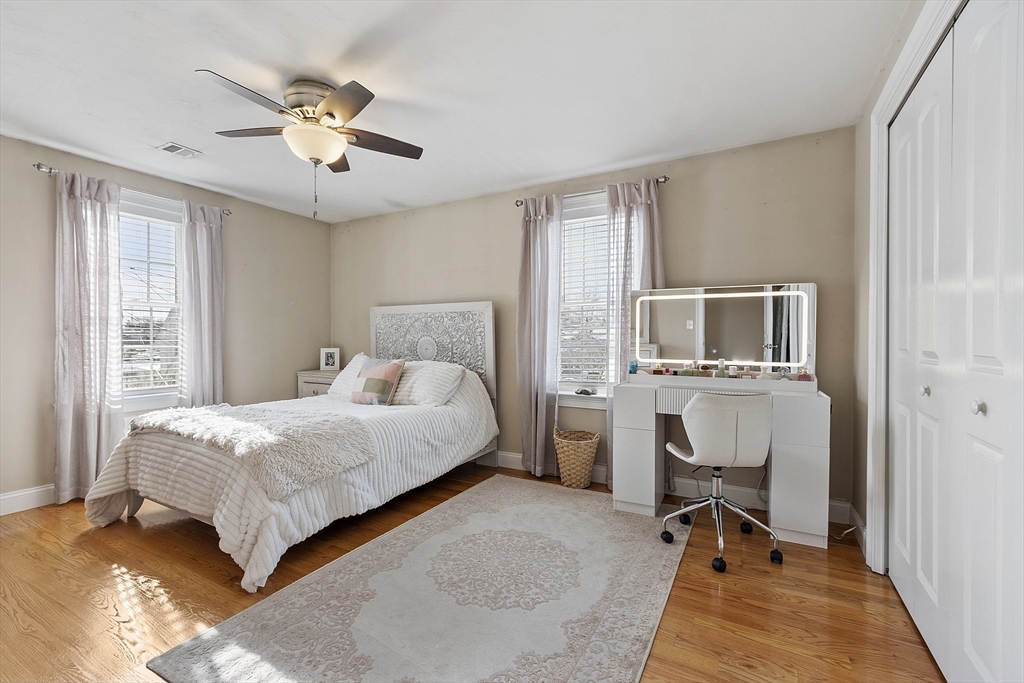 103 Reed Street Rockland, MA 02370 - Photo 21 of 33 a bedroom with a bed and a chandelier