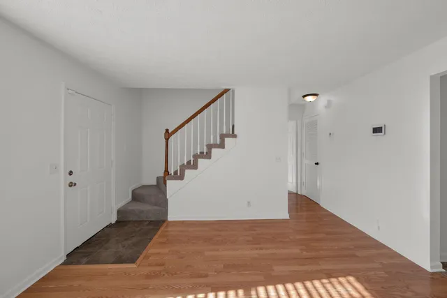 a view of entryway and hall with wooden floor