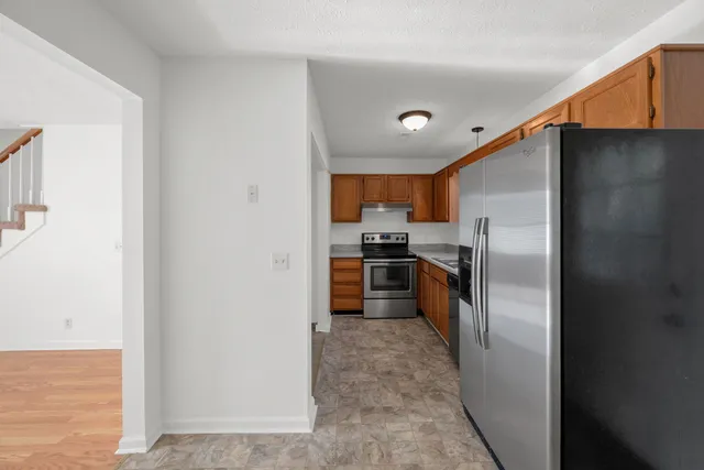 a kitchen with a refrigerator and a sink