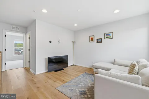 a bedroom with furniture and a wooden floor