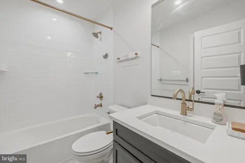 a bathroom with a sink a toilet and a bathtub