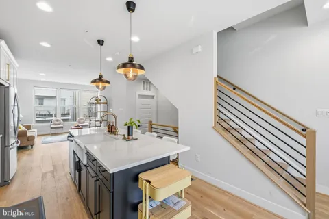 a kitchen with a sink appliances and cabinets