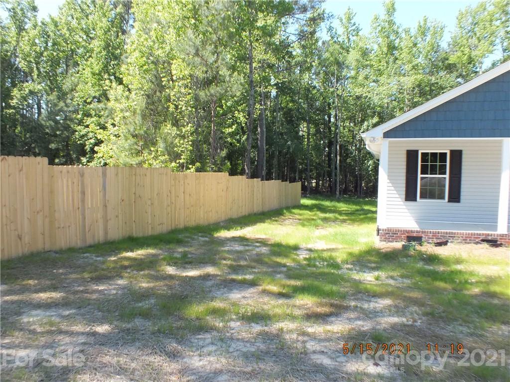 2302 Douglas Road Lancaster, SC 29720 - Photo 2 of 17 a view of a backyard with a small cabin