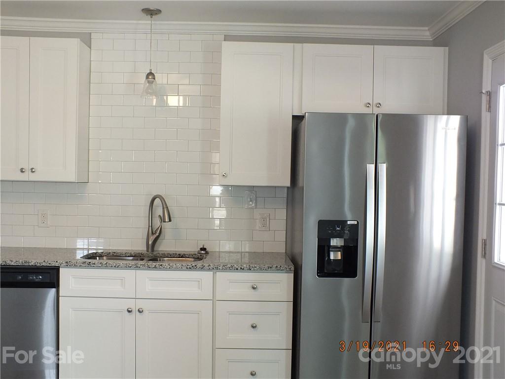 2302 Douglas Road Lancaster, SC 29720 - Photo 5 of 17 a kitchen with stainless steel appliances granite countertop a refrigerator and a sink