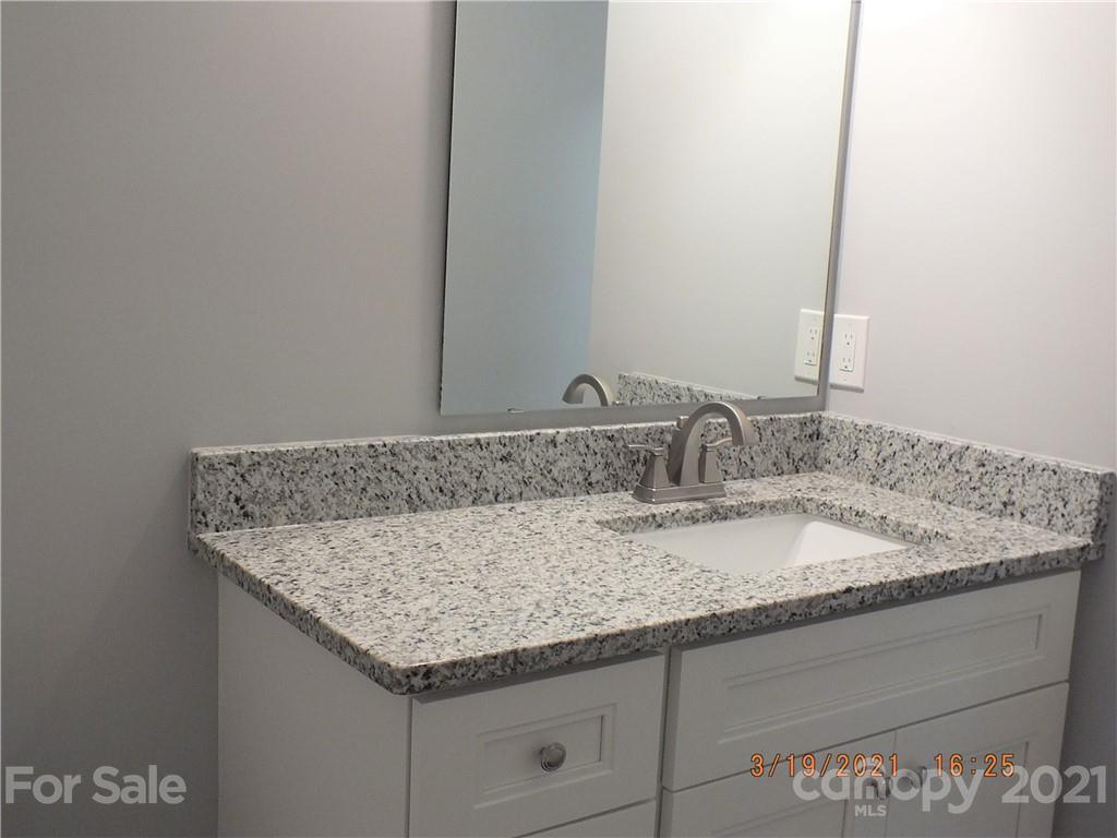 2302 Douglas Road Lancaster, SC 29720 - Photo 8 of 17 a bathroom with a granite countertop sink and a mirror