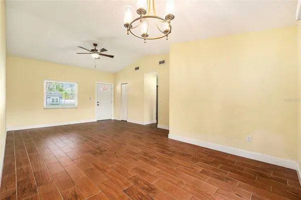 a view of empty room with wooden floor