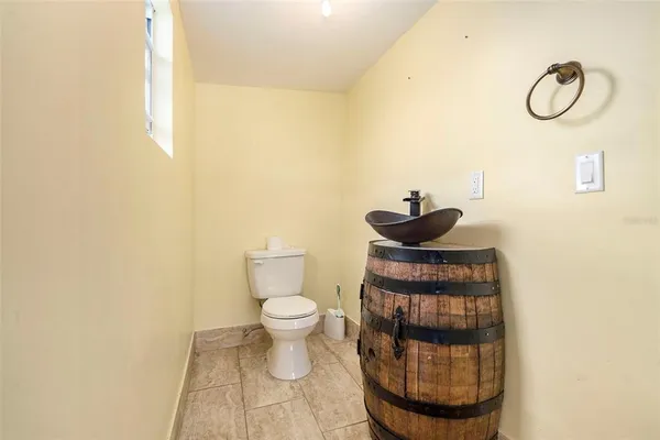 a bathroom with a toilet and a mirror