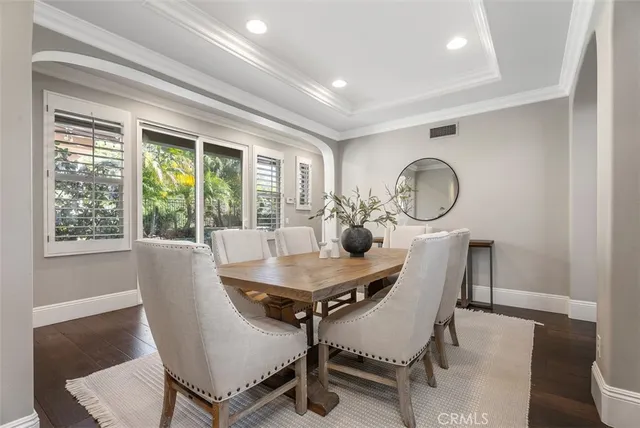 a kitchen with a table chairs refrigerator and cabinets