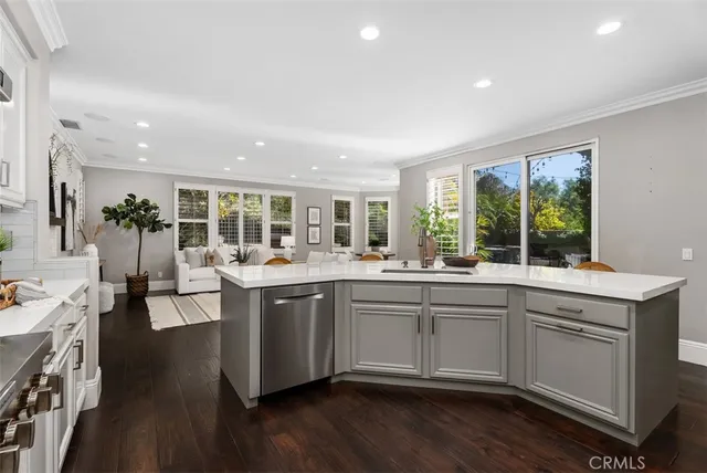 a living room with furniture a large window and a fireplace