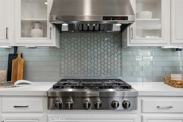 a spacious bedroom with a bed a chandelier and a window