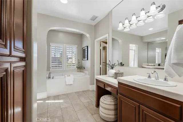 a bedroom with a bed a window and a night stand