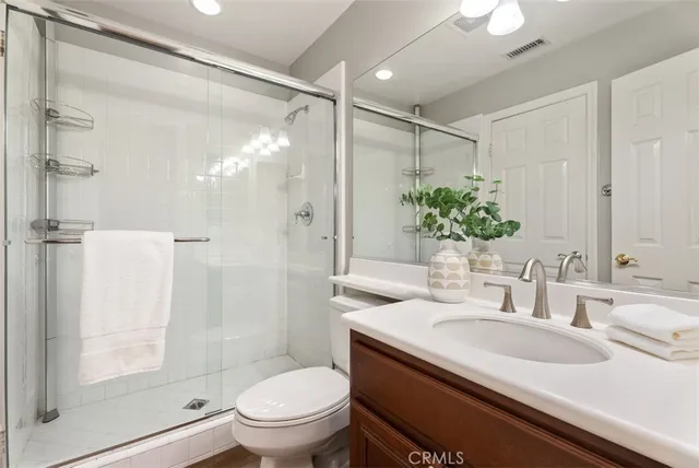 a view of a hallway with wooden floor and furniture