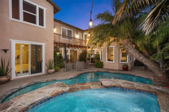 a front view of a house with a yard table and chairs