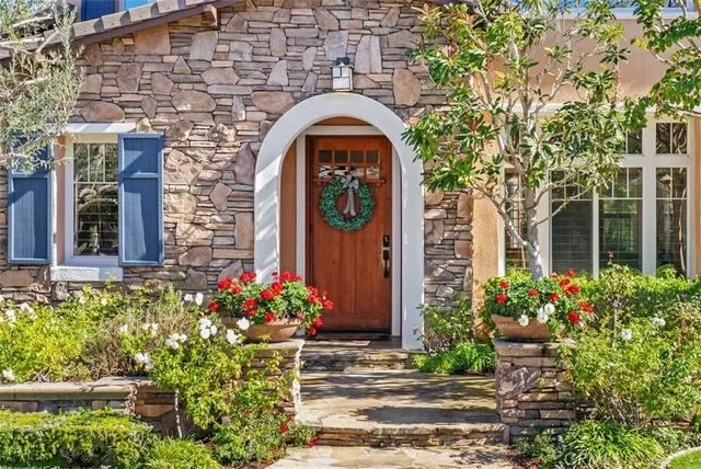 a living room with furniture a fireplace and a large window