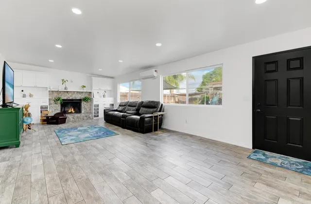 a living room with furniture a fireplace and a flat screen tv