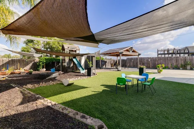 a view of a patio with table and chairs potted plants with palm trees