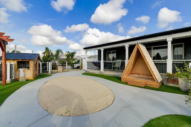 a view of a house with a swimming pool and sitting area