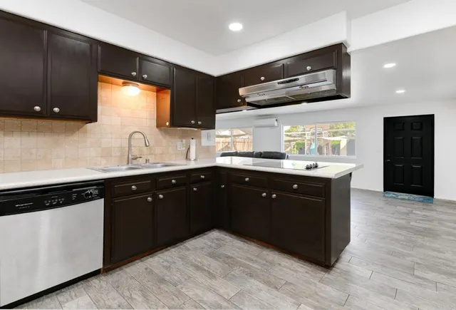 a kitchen with a sink a stove and cabinets